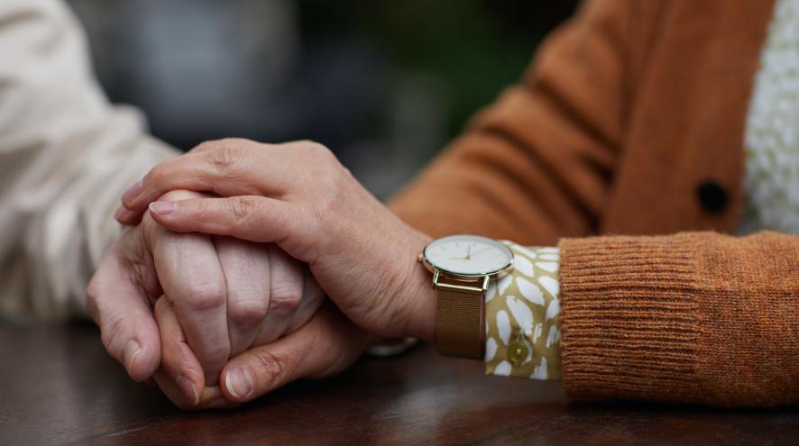 Two people holding hands